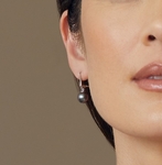 Model is wearing Elegance earrings with 9mm Tahitian pearls